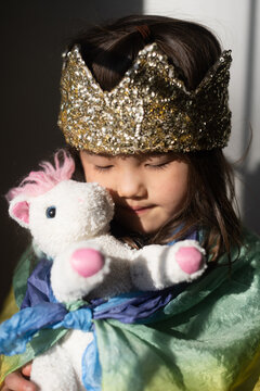 Little girl with unicorn stuffed animal