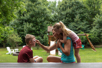 Mother Putting Sunscreen on Child 