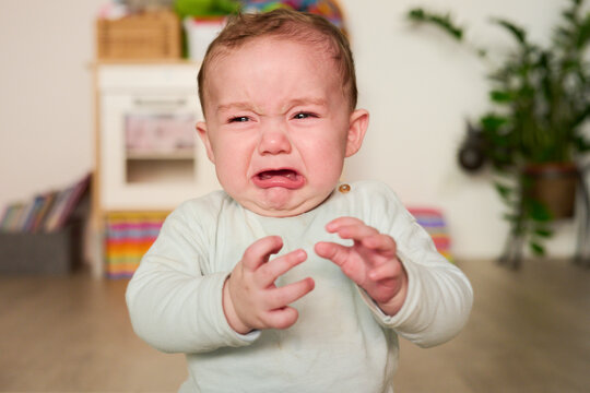 Unhappy cute baby in tears. Cry.