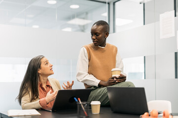 Multicultural Coworkers Chatting in Office
