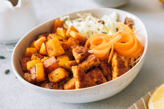 Sauteed pumpkin with spicy tempeh and fresh salad