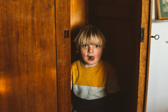 A toddler hiding in a closet