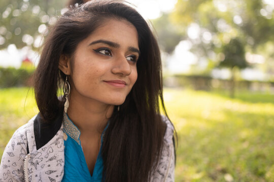 Portrait of a smiling  young Indian girl at outdoors