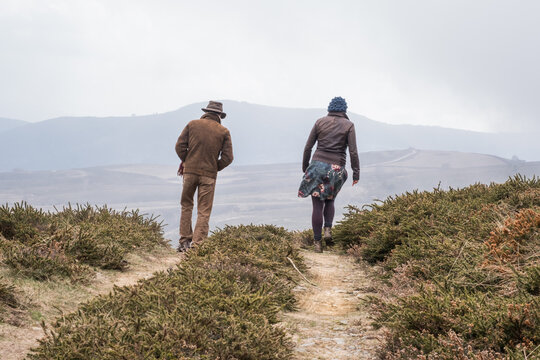 A Man And A Woman Walking In Nature, From Behind