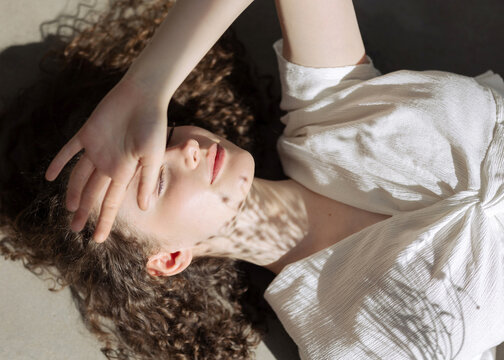 Portrait young girl squinting the sun