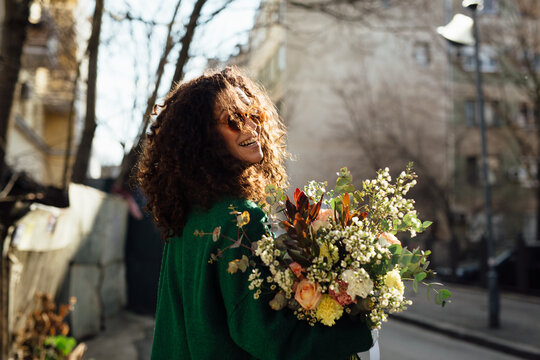 Woman Walking With Flower Bouquet