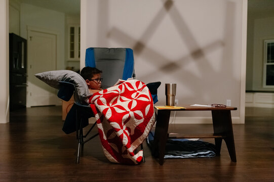 Child relaxing while reading a book. 