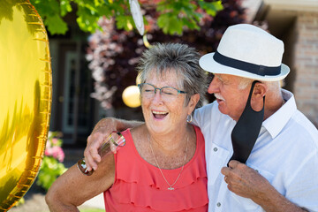 Senior Citizen Couple Laughing at Golden 50th Wedding Anniversary