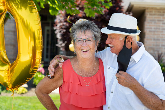 Senior Citizen Couple Smiling at Golden 50th Wedding Anniversary