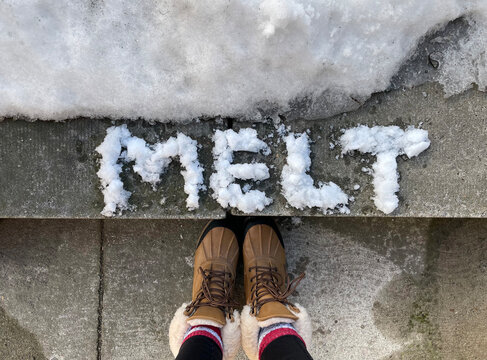 the word "melt" written in snow