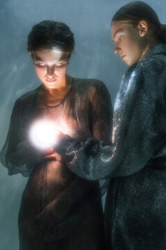 Young witches practicing with light