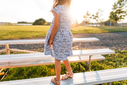 Child balancing on bleachers. 