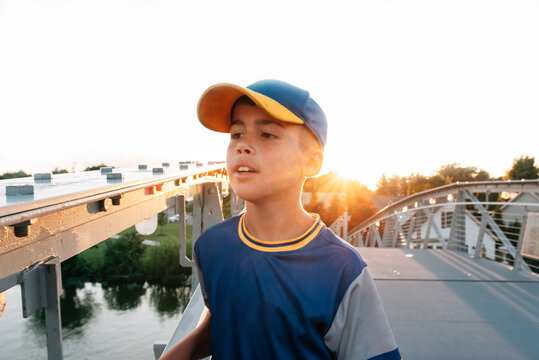 Baseball player walking on a bridge. 