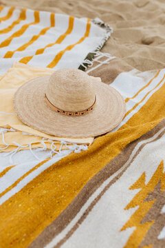 Fototapeta Sunhat on yellow beach blankets