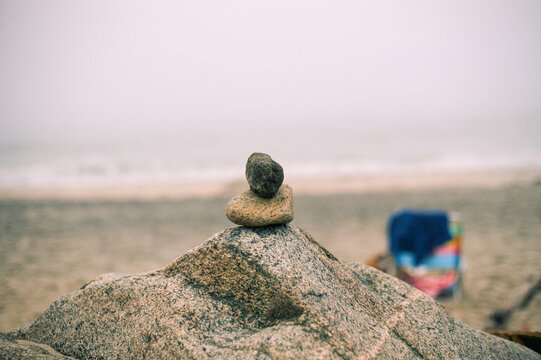 little rock stacked big rock a the beach 