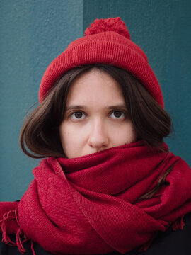 Cold look female portrait in red cap and scarf