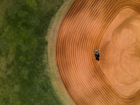 A tractor rakes a Baseball Field Aerial View