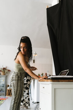 Woman with dreadlocks using a laptop
