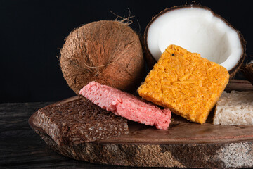Cocada coconut candy, sweet Brazilian in rustic wood background