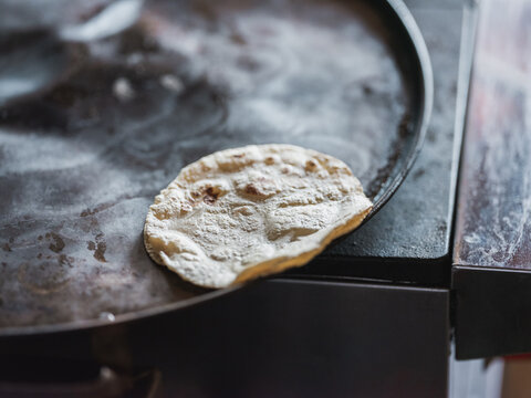 Cooking flour tortillas in a pan. 