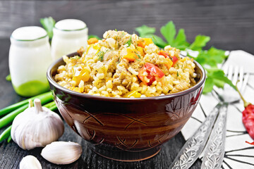 Barley porridge with minced meat in bowl on board