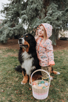 Adorable Girl with her Easter Egg Basket and Dog