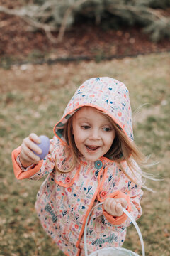 Excited Young Girl Finding Easter Eggs