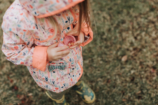Girl Finding Candy in Easter Egg