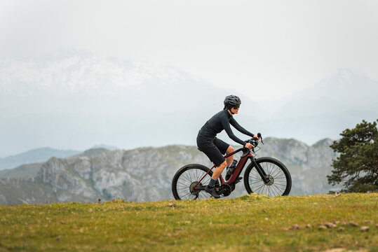 Sportive bicyclist working out on e bike in mountains 