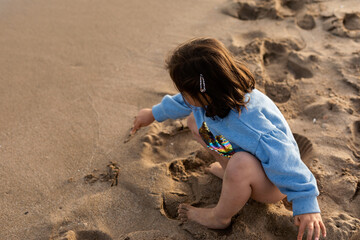 child playing in the beach