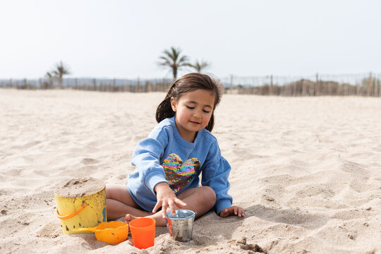 smiling child playing in the sand
