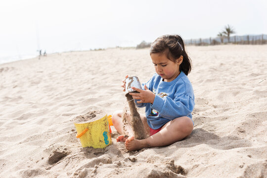 child playing in the sand