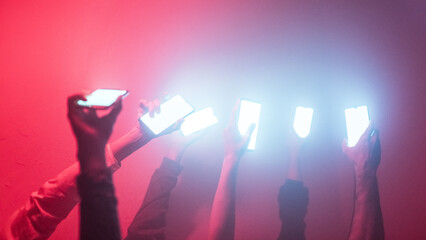 Hands holding iluminated devices