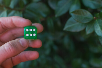 Green dice with the number 6