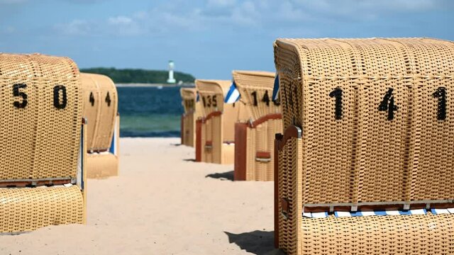 4K 60fps video of beach chairs on white sand beach during windy sunny weather ot Baltic sea in Kiel fjord
