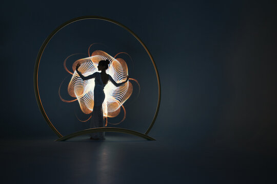 Silhouette of a woman on light painting