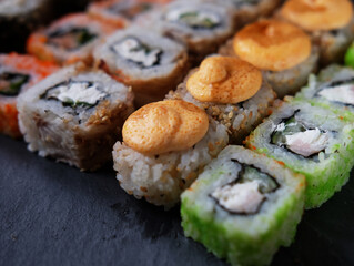 Overhead japanese sushi food. Maki ands rolls with tuna, salmon, shrimp, crab and avocado.