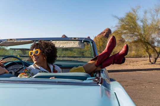 Happy Friends Talking in Vintage car on road trip 