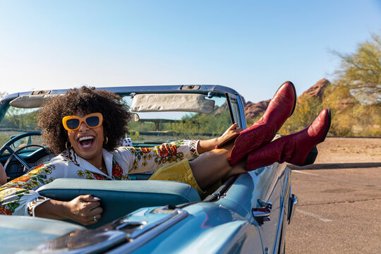 Happy Friends Talking in Vintage car on road trip 