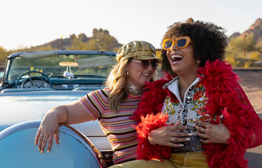 Young Happy Friends Laughing next to Vintage Car 