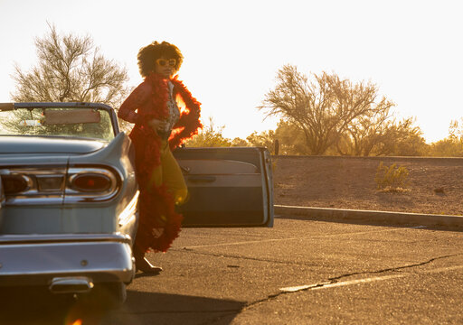 Woman Get out of car on Fashion Shoot with Vintage Automobile 