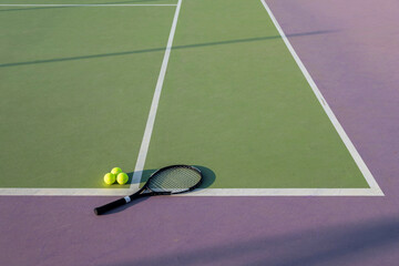 Tennis racket and ball on a colorful court