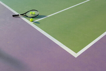 Tennis racket and ball on a colorful court