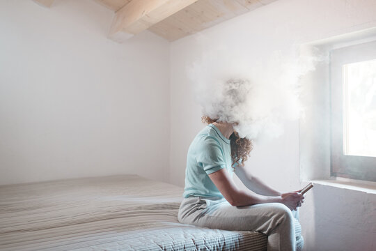 Woman with her head inside a smoke cloud
