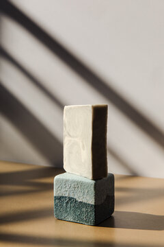 Stacked soap bars in a sunny studio 