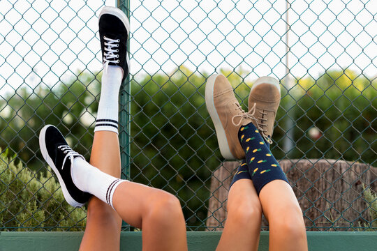 Crossed teenagers legs with socks lying on the floor 
