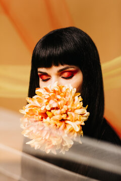 Studio Portrait of a girl holding a peony
