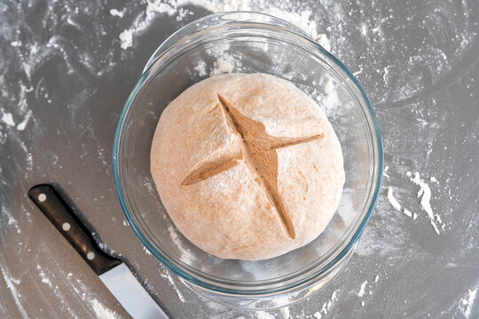 A raw bread dough with two marks ready to cook.