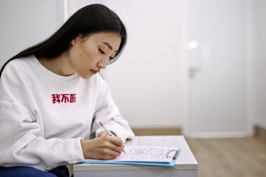 Asian woman preparing documents for medical examination 