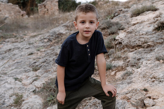 Boy standing on rocks in a mountain
